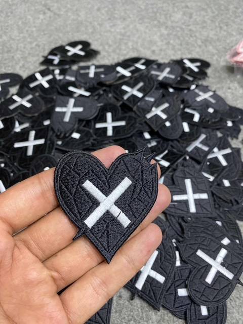 Close-up of engraved metal hardware and custom pocket patches